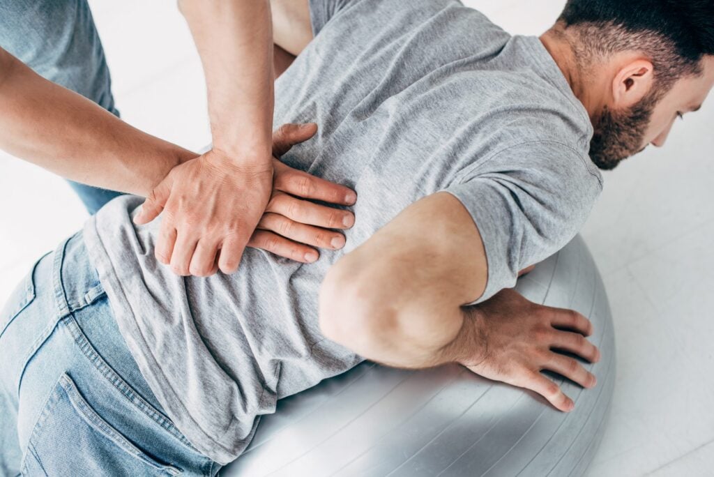 Doctor attending to a patient lying down in a wellness clinic – professional care setting showcased for wellness marketing impact.