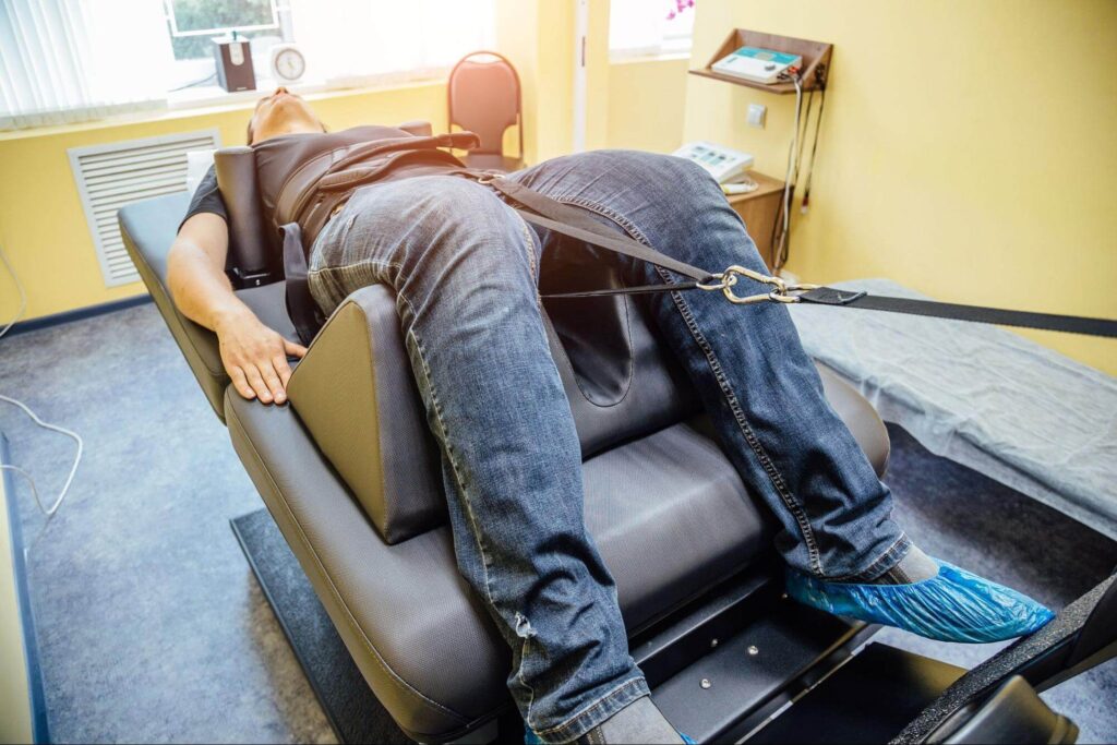 Man receiving medical decompression therapy on a specialized table — effective imagery for spinal decompression marketing materials.