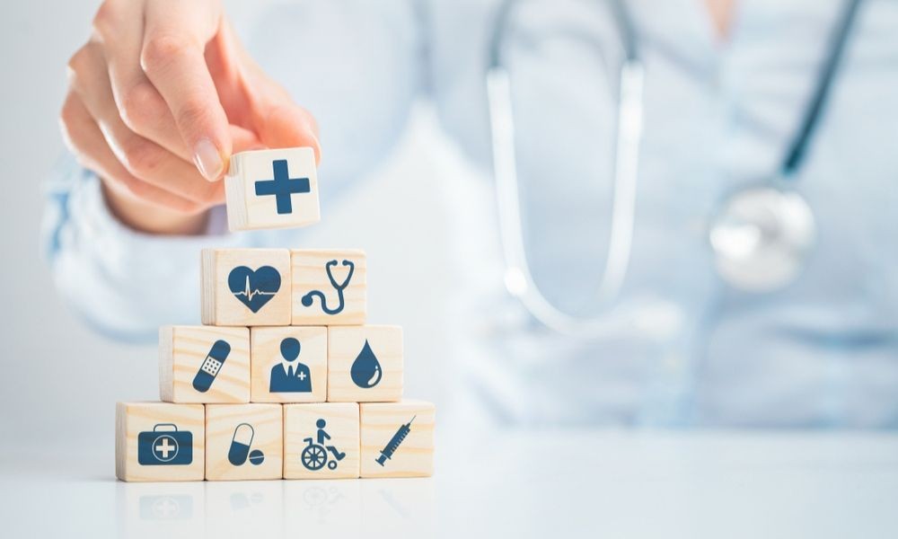 Doctor holding a tablet displaying a modern healthcare branding logo